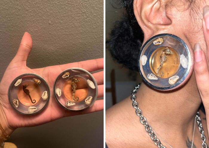 A person holding and wearing creative earrings featuring a seahorse and seashells encased in resin. Artistic trash into useful jewelry.