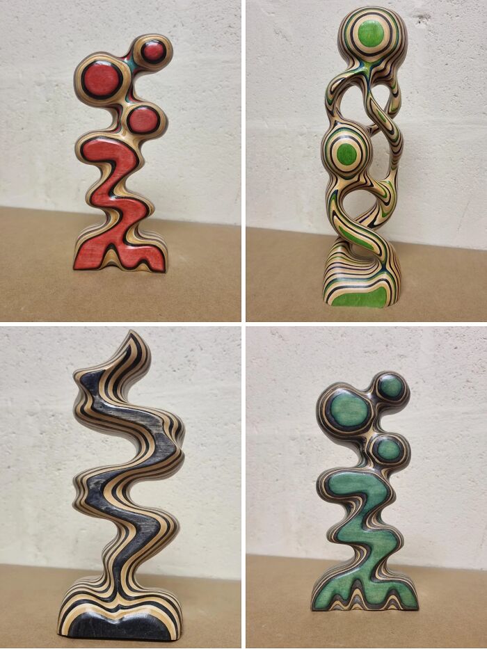 Four abstract wood sculptures made from layered trash, showcasing creative people's artistic transformation of recycled materials.