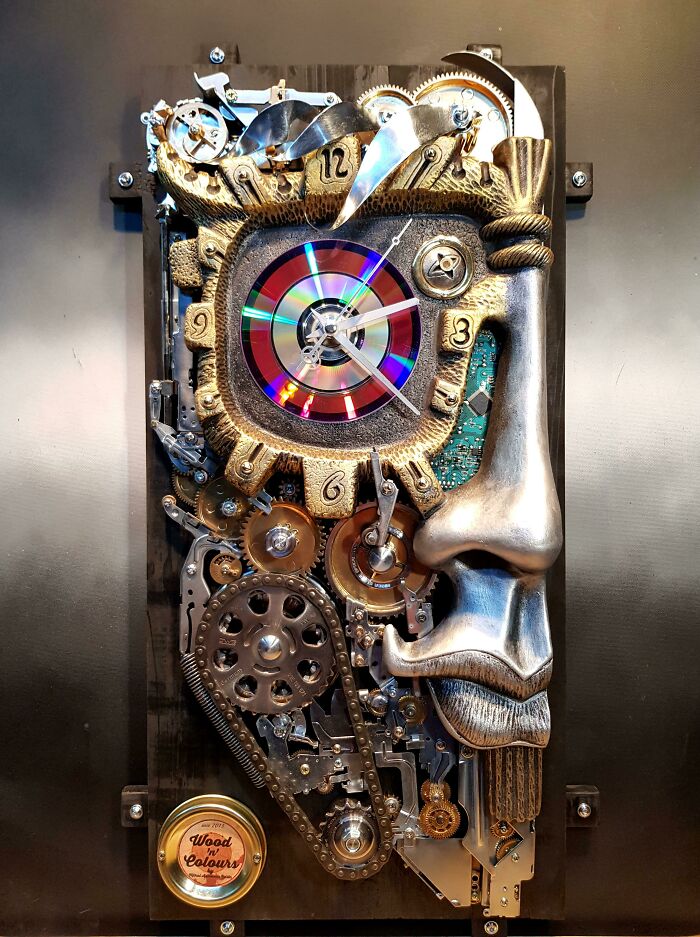 A unique steampunk-style clock face made from creatively repurposed trash, forming an artistic human profile.