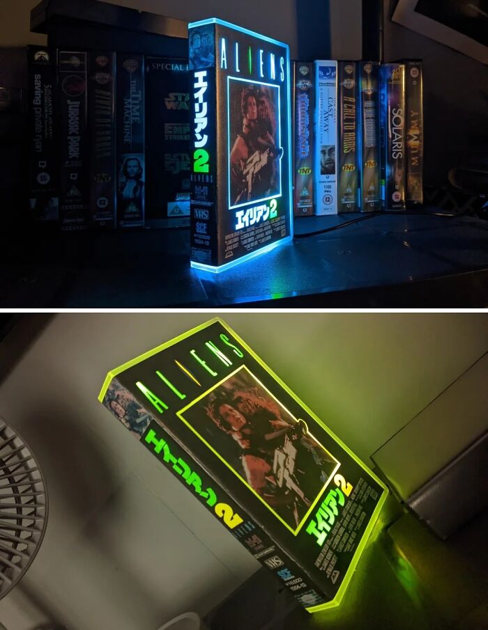 A VHS tape of Aliens, repurposed and glowing with blue and green lights, showcasing creative people turning trash into art.