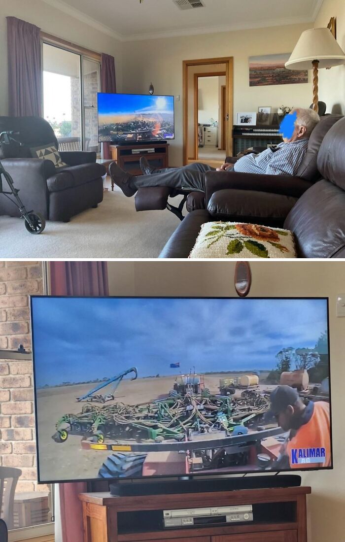 A person relaxing in a recliner watching a TV show about heavy farm equipment in a field. Live on a farm scenes that confuse city kids.