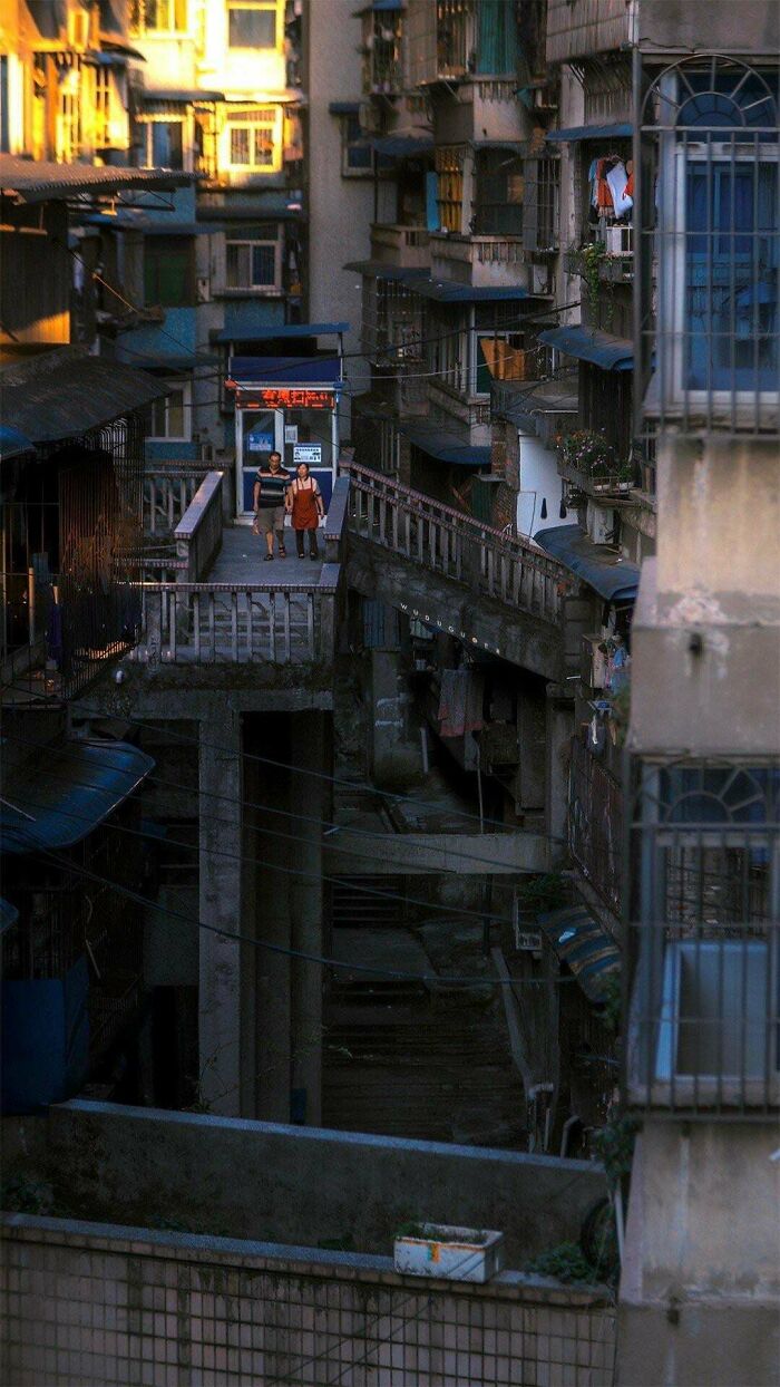 Narrow dark alley with worn apartments in urban hell street