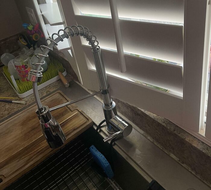 A kitchen sink with a chrome spring faucet and white plantation shutters above. A DIY home improvement fail in progress.