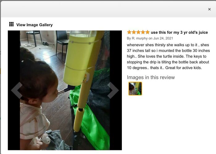 A child drinks from a mounted water bottle on a play structure, an honest review of a product. A huge disappointment.