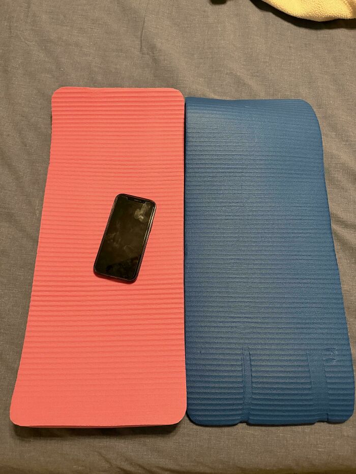Smartphone on a small pink mat next to a blue mat, often indicating sizing surprises from Temu Or AliExpress purchases.