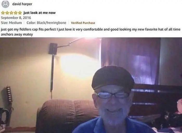 A smiling man in a black fiddlers cap and glasses with a text review saying "just look at me now." Hilariously honest reviews.