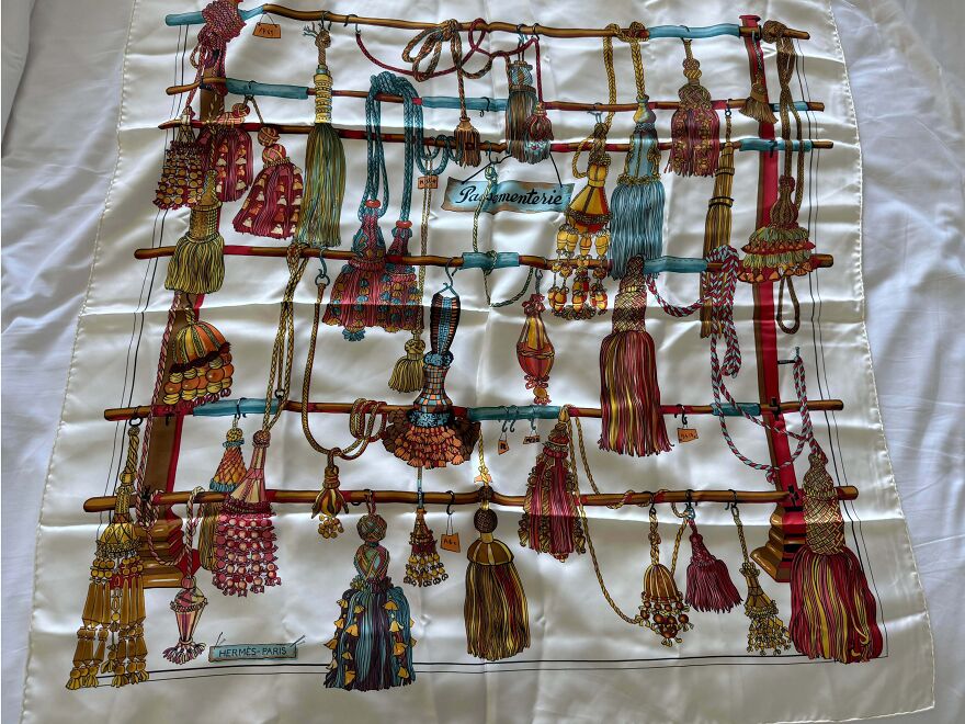 A vintage Hermes scarf featuring colorful tassels, a suspicious good thing found in the Goodwill bins.