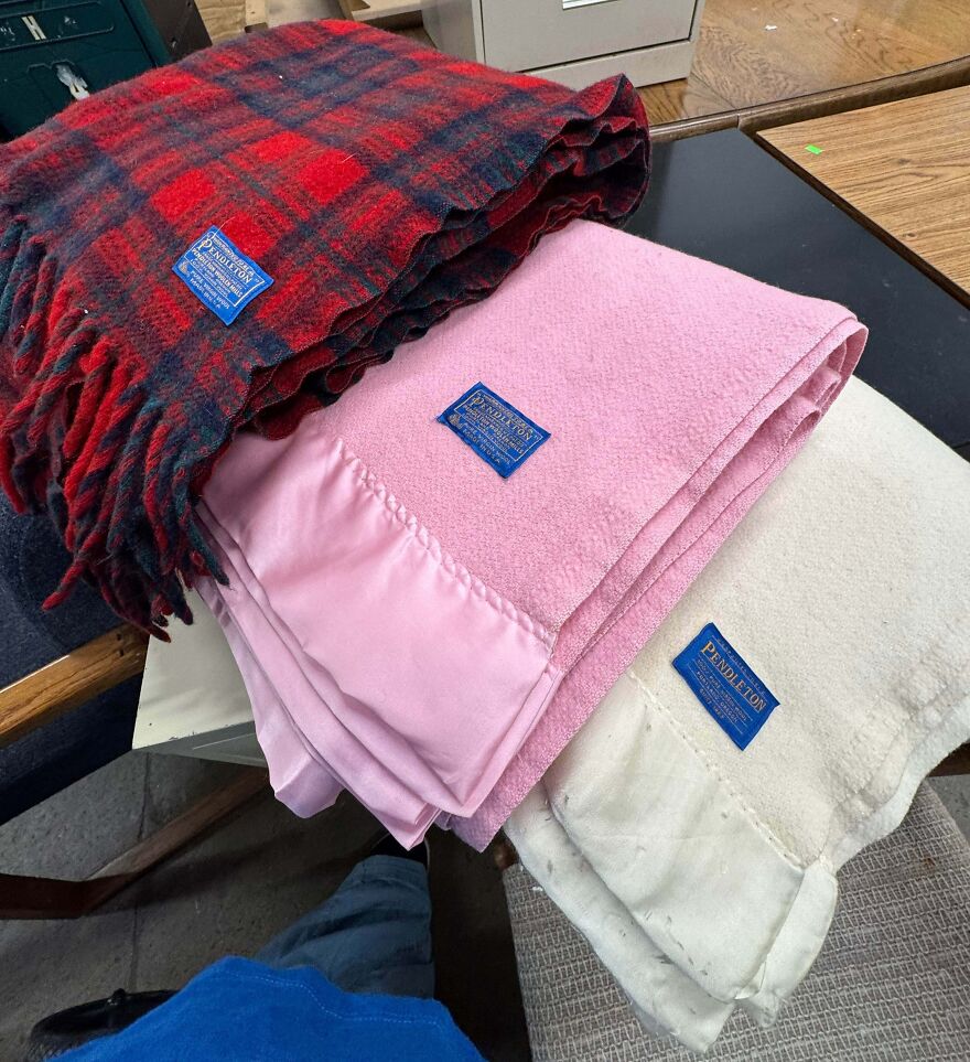 Pendleton blankets in red plaid, pink, and cream, found at Goodwill. A gold bar of a find among Goodwill bins!