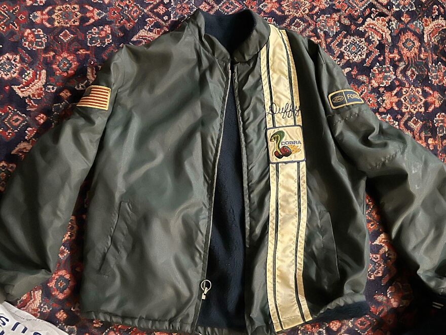 A vintage racing jacket with a Cobra patch and Ford logo, among suspicious finds in the Goodwill bins.