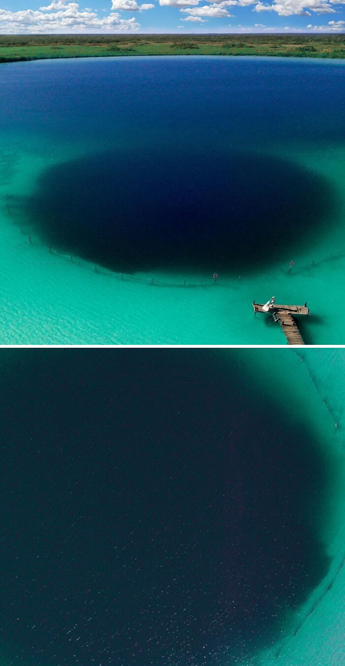 An aerial view of an uncomfortable water pic showing a deep, dark sinkhole in turquoise water with a small pier.
