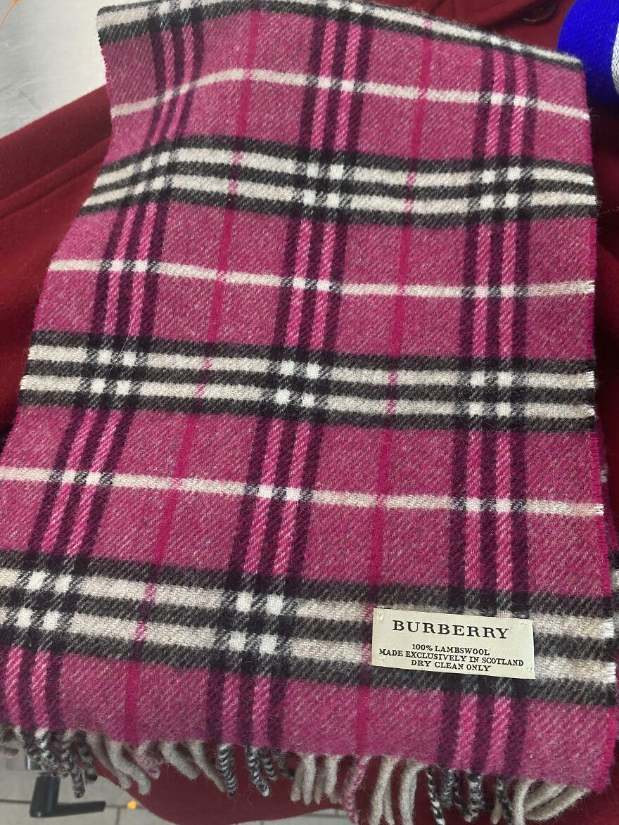A pink plaid Burberry scarf, possibly found in the Goodwill Bins. The label reads "100% Lambswool, Made Exclusively in Scotland."