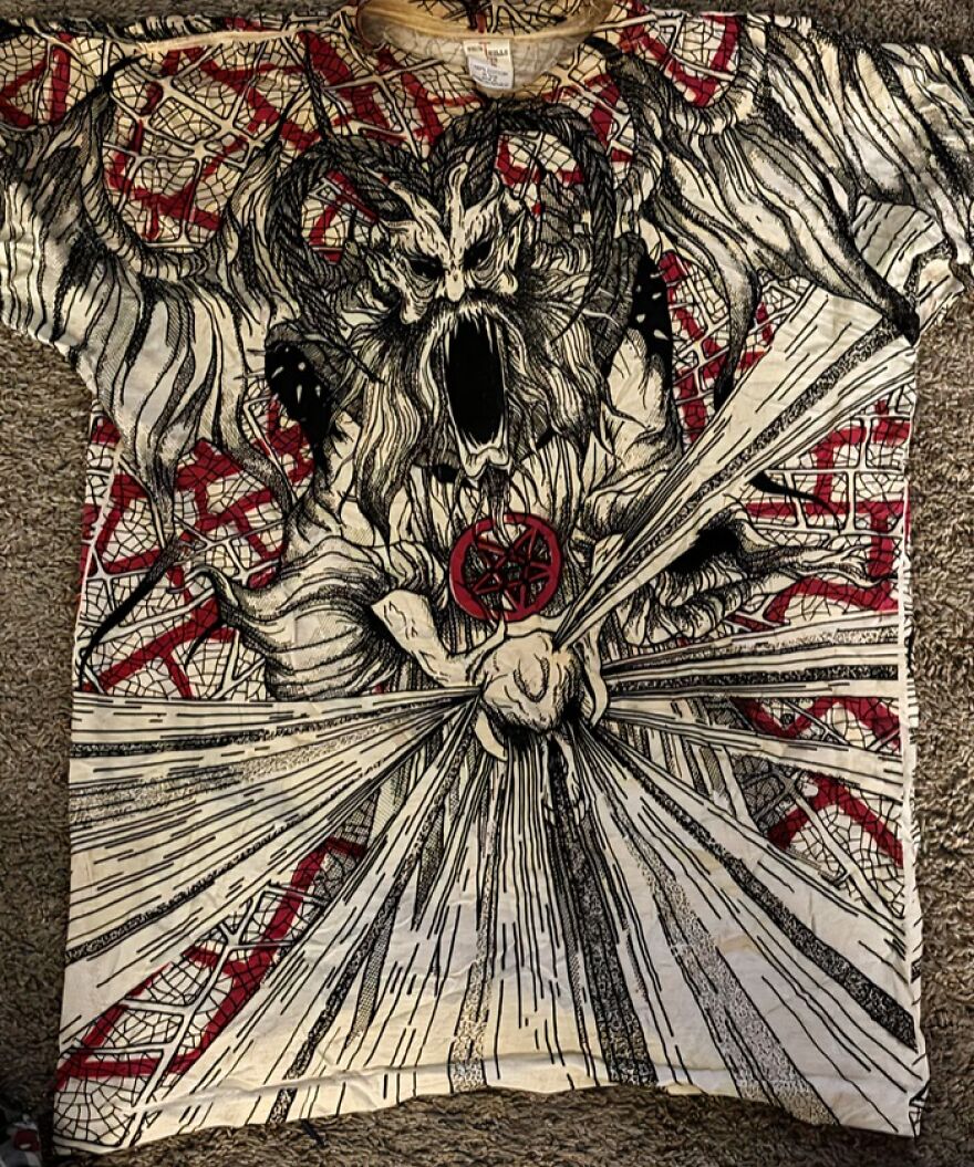 A detailed graphic tee featuring a screaming horned creature. A suspicious find in the Goodwill bins.