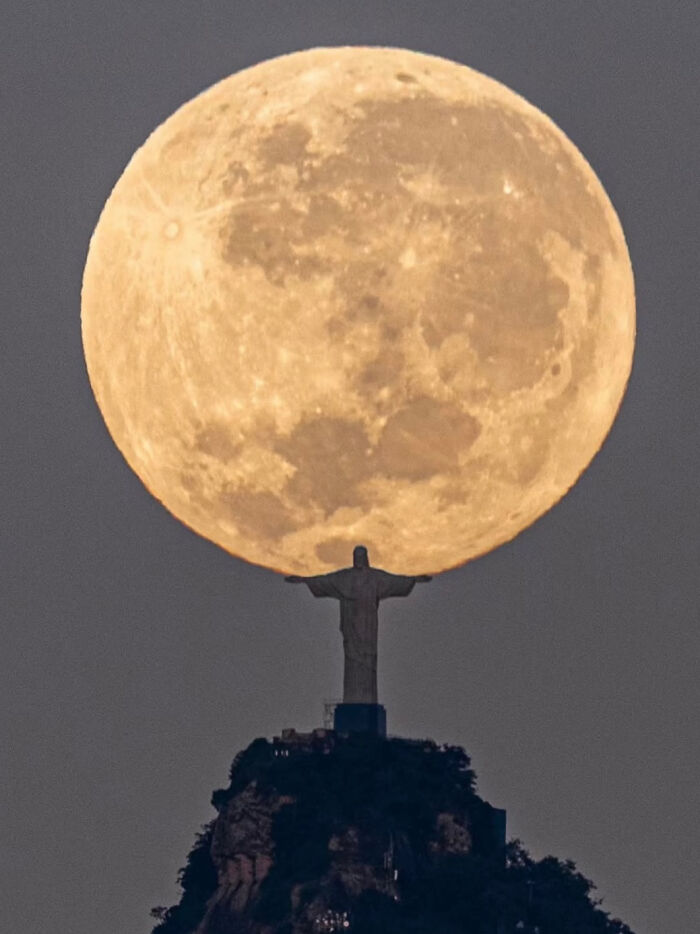 An interesting and uplifting post showing a supermoon behind the Christ the Redeemer statue in Rio de Janeiro, Brazil.