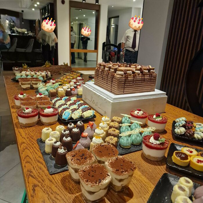 Variety of beautiful desserts arranged on a wooden table at a celebration event