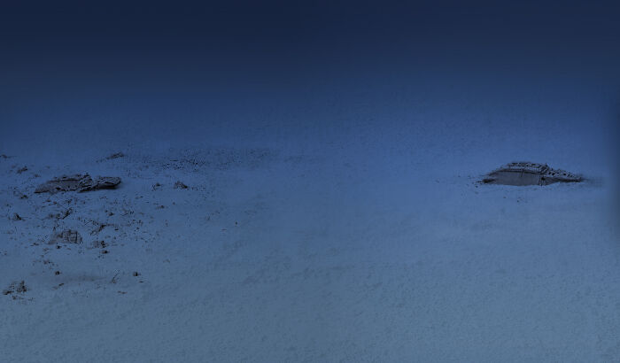 Dark blue underwater scene with submerged rocks and debris, creating an uncomfortable water pic that makes you feel small.