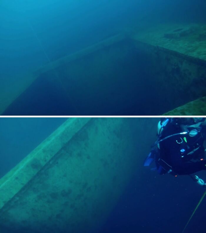 A diver explores the colossal structure of a sunken ship, highlighting the immense scale of uncomfortable water pics.