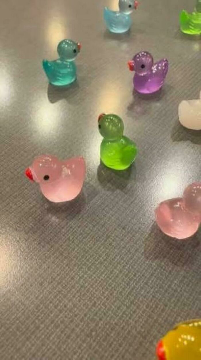 Colorful tiny rubber ducks scattered on a surface, highlighting how insulting consumerism has gotten with varied prices.