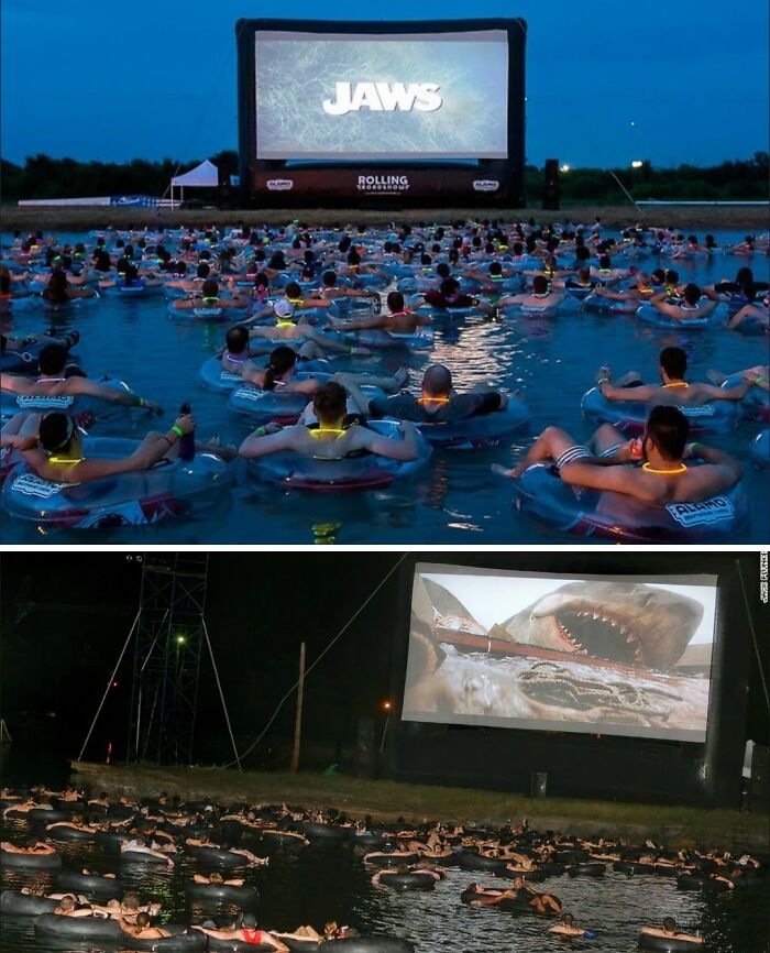 Uncomfortable water pics of people watching Jaws on a giant screen while floating in inner tubes on water, feeling small.