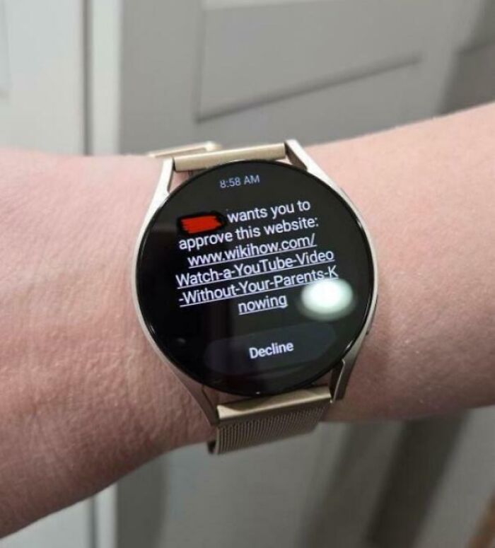 A smartwatch displaying a request to approve a wikiHow page about watching YouTube secretly. Funny kid moment.