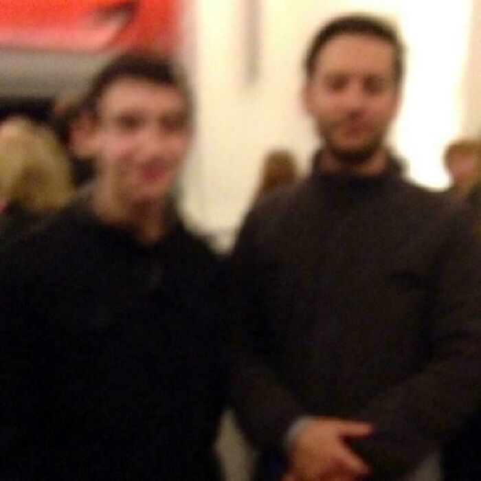 Blurry photo of two men, one smiling, for wild photos of celebrity encounters.