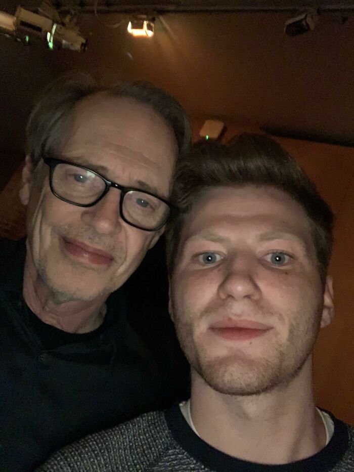 A selfie of actor Steve Buscemi wearing glasses next to a younger man, both smiling. A celebrity encounter photo.
