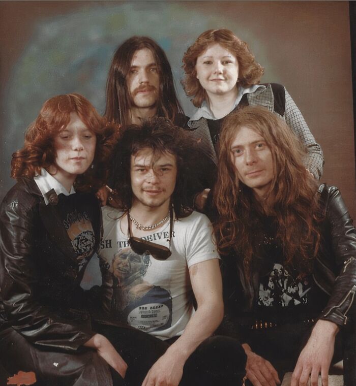 A group of five individuals, three men and two women, posing for a photo. Wild photos of celebrity encounters.