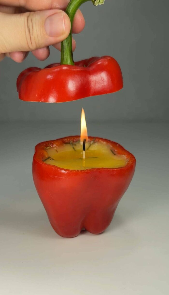 A handmade candle inside a red bell pepper, a creative and magical project.