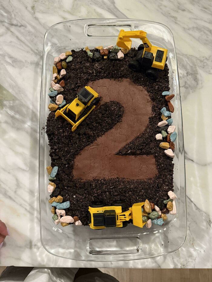 Construction themed chocolate dessert with toy trucks and edible rocks