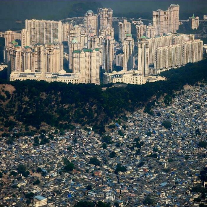 Urban hell contrast between dense slums and luxury high-rise buildings