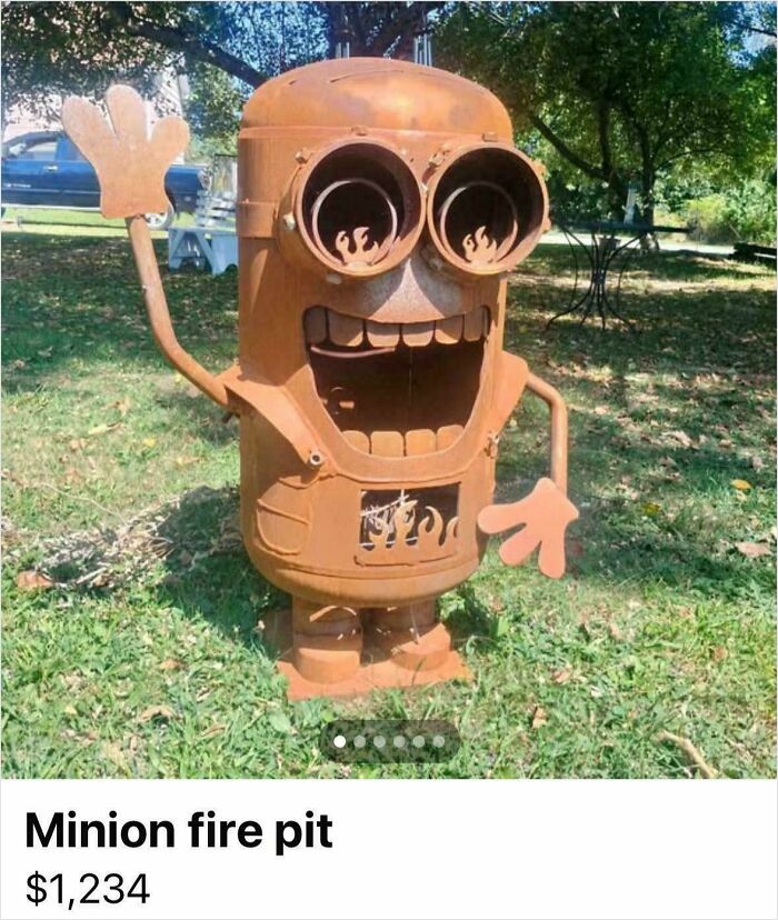 A rusty Minion fire pit sculpture, a DiWHY creation that failed miserably, stands in a grassy yard.