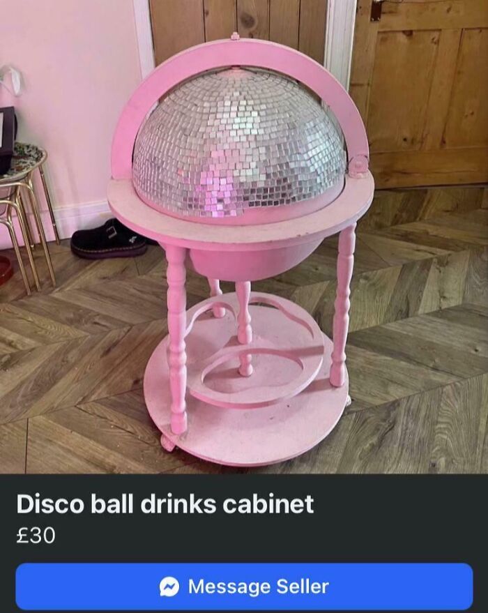 A pink DiWHY disco ball drinks cabinet, a DIY project, sitting on a wooden floor, for sale.