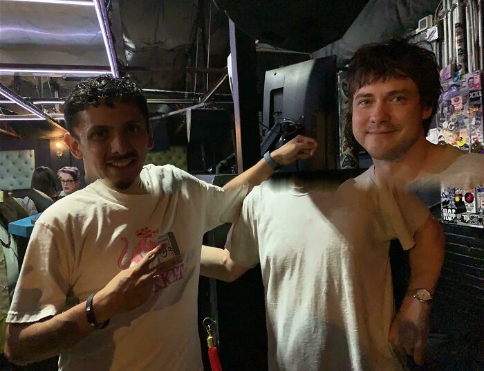 Two men smiling at a celebrity encounter. One points at his shirt with a pink panther logo. Wild photos of celebrity encounters.
