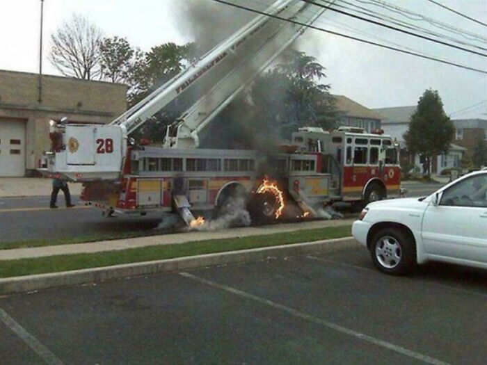 A funny fail where a fire truck is on fire, with flames visible under the vehicle.