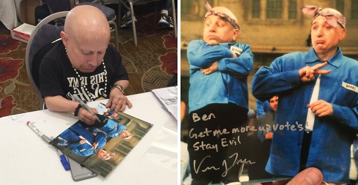 Celebrity Mini-Me signing a photo of himself in a blue uniform, a wild celebrity encounter.
