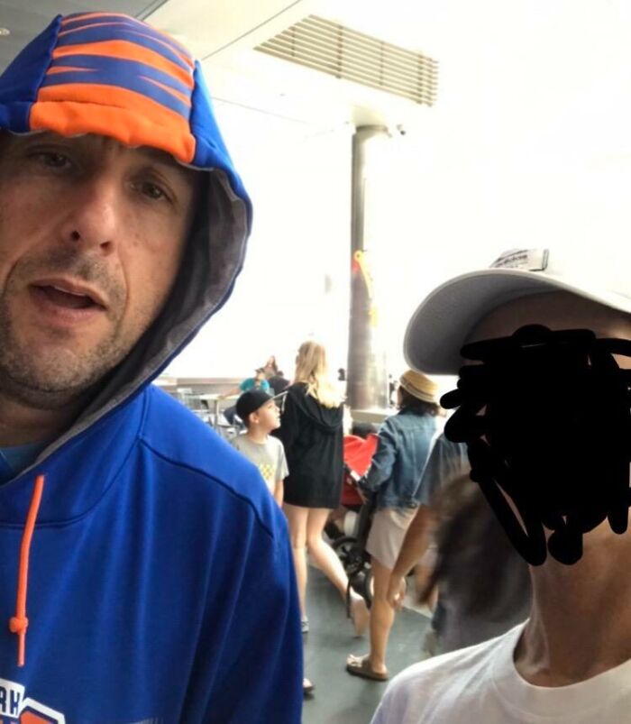 A close-up selfie of a celebrity encounter with a man in a blue and orange hoodie. Wild photos of celebrity encounters.