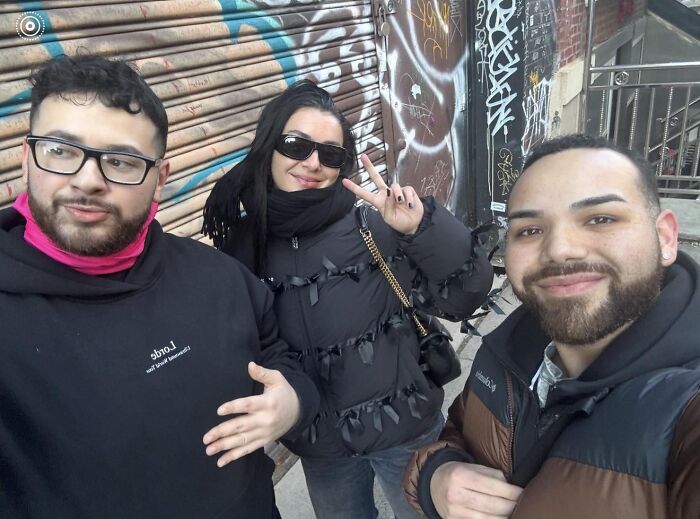 Three friends taking a selfie, one making a peace sign, symbolizing wild celebrity encounters.