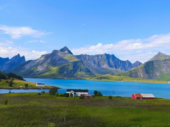 A beautiful fjord with mountains and houses by blue water, a gentle reset button for your day.