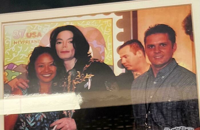 A framed photo of Michael Jackson with a woman, and a man smiling at the camera, capturing wild celebrity encounters.