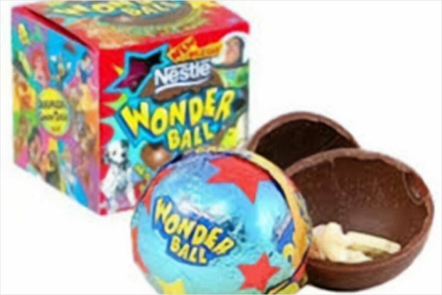 A Wonder Ball package and two unwrapped chocolate Wonder Balls, one with a toy inside. Take a trip down memory lane with this classic candy.