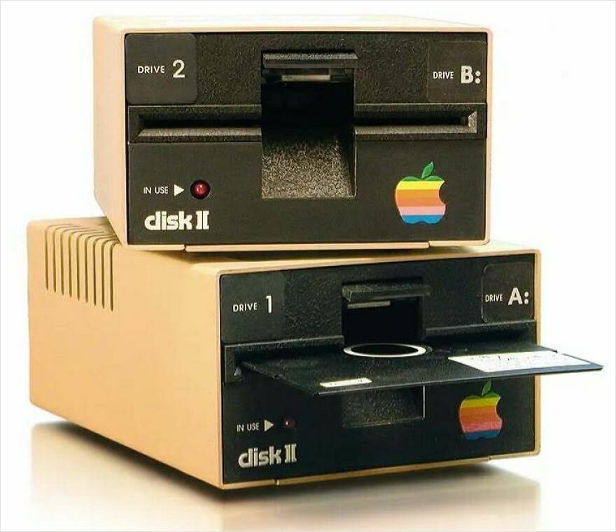Two stacked vintage Apple Disk II drives with a floppy disk partially inserted, a trip down memory lane for tech enthusiasts.