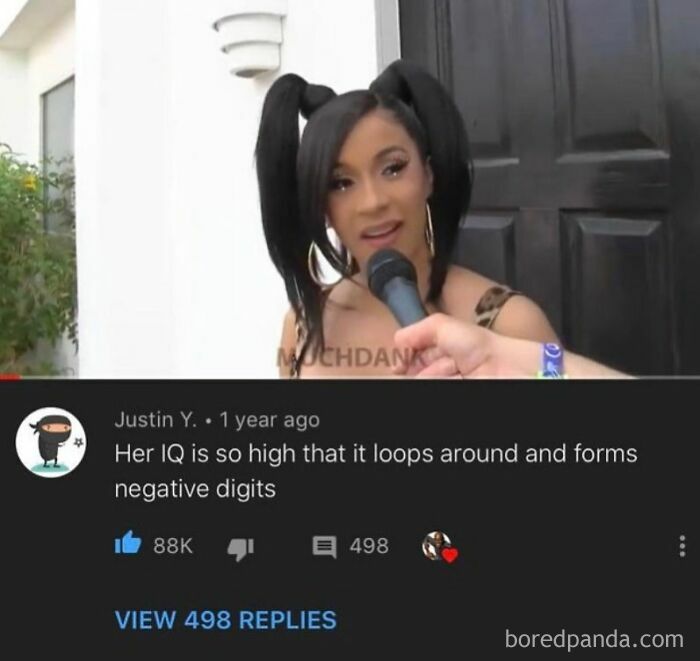 Cardi B being interviewed with a comment below calling her intelligence a rare burn.