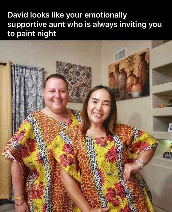 A man and woman smiling in matching yellow and orange patterned kaftans, a rare burn fashion.