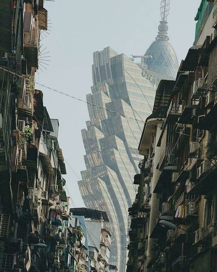 Contrasting urban hell street with old apartments and modern twisted glass skyscraper