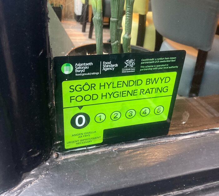 Food hygiene rating sticker showing urgent improvement needed with zero rating