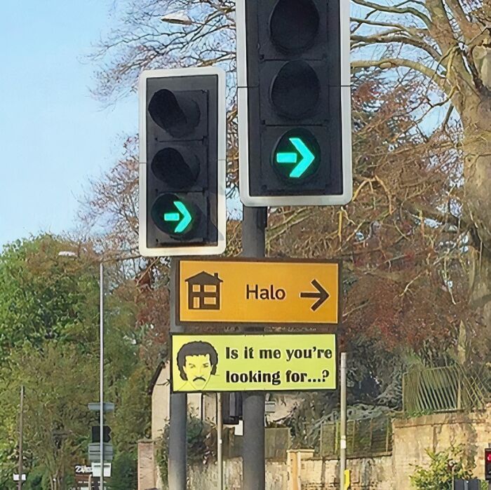 Creative British road sign with green arrows and lyrics joke