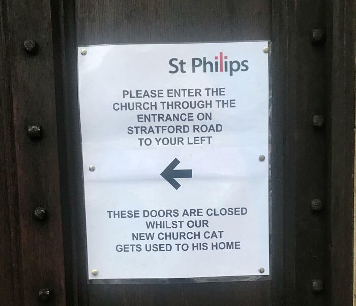 Church sign asking visitors to enter from Stratford Road due to cat adjustment