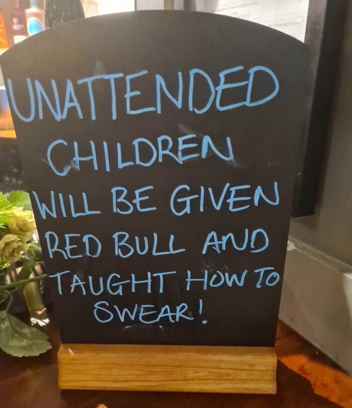 Chalkboard sign warning unattended children will get Red Bull and learn to swear