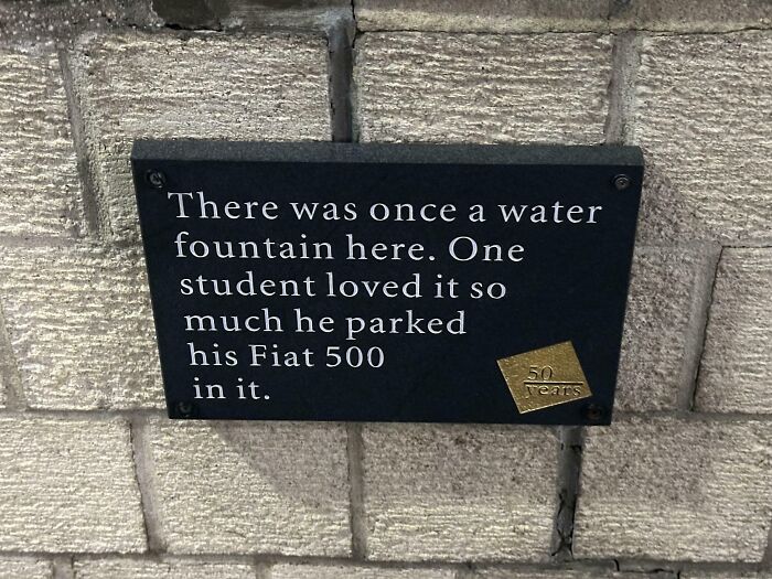 Plaque humorously describing a Fiat 500 parked in a former water fountain