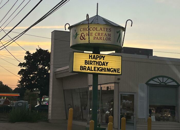 A Chocolates & Ice Cream Parlor sign with a birthday message for Braleighingne, a unique kid's name.