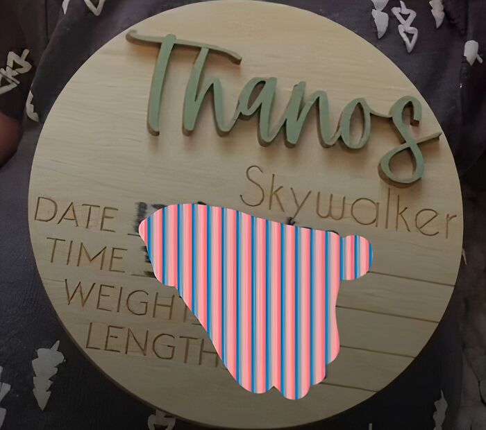 A wooden baby name sign reading "Thanos Skywalker" with birth details below. Parents naming their kids can find this relevant.